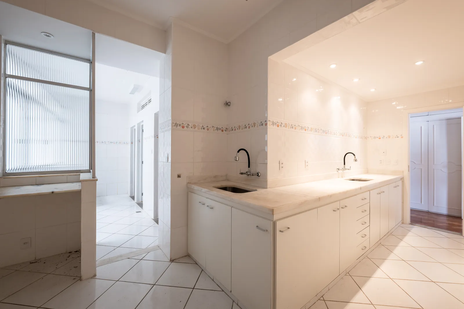 A second kitchen and service area, finished in white