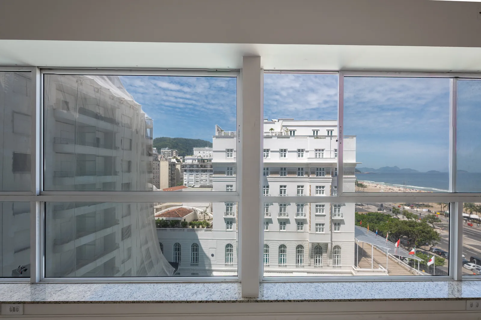 The Copacabana Palace and the beach framed by the apartment's window